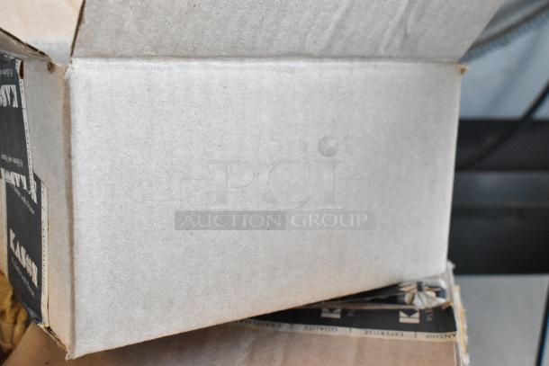 Open cardboard box with visible labels mentioning quality and craftsmanship. Box appears slightly worn.