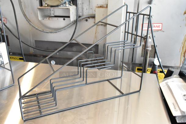 Black wire rack cooling rack with stair-step design, ideal for sheet pans, in excellent condition, no visible markings.