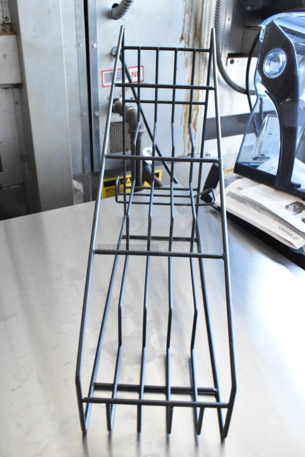 Black metal wire display rack with multiple tiers, suitable for countertop use. In good condition, ideal for retail display.