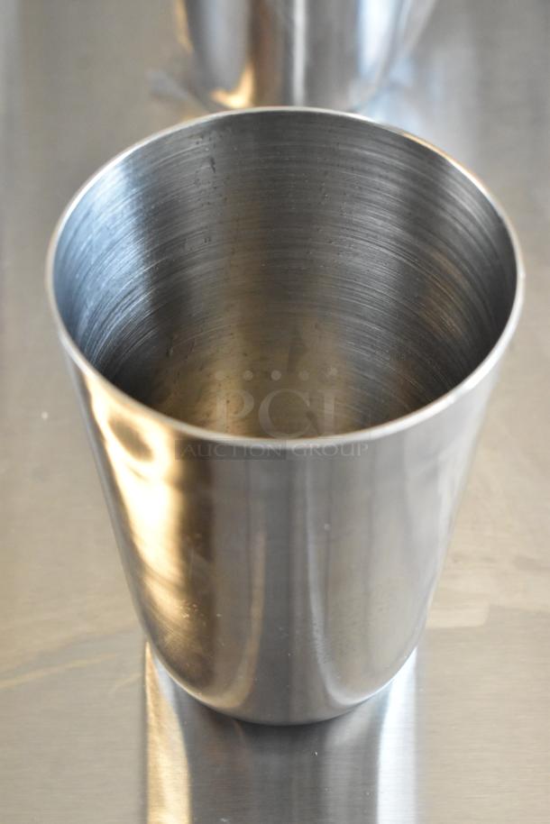 Stainless steel cup with smooth finish, minimal wear, and slightly flared rim. Ideal for industrial or minimalist decor.