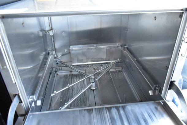 Stainless steel industrial oven interior with rotating racks, in clean condition. Ideal for high-volume baking applications.