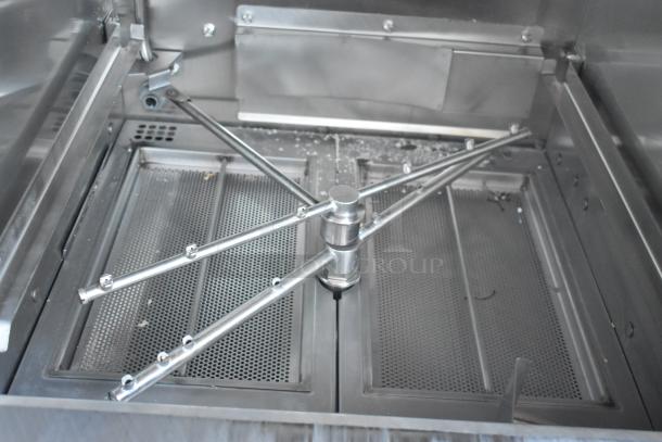 Stainless steel industrial mixer, rotary arm, mesh filters, used condition, suitable for heavy-duty mixing.