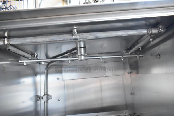 Stainless steel industrial mixer interior, features robust metal rods and fixtures, excellent condition.