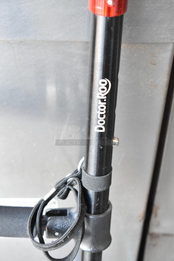 Black Doctor Roo golf ball retriever, featuring a locking mechanism and a strap. Good condition.
