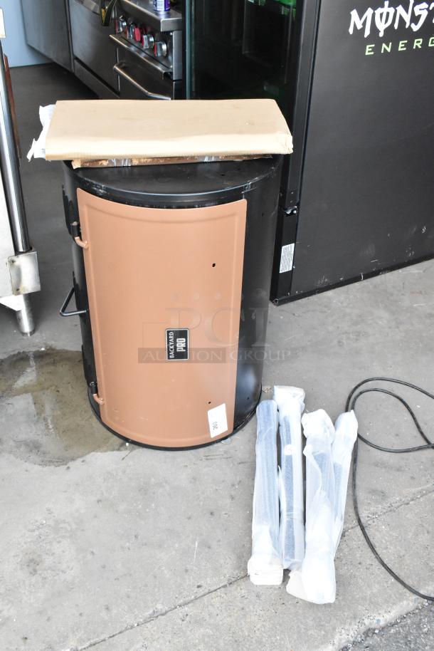 Backyard Pro charcoal smoker in brown, new condition, with assembly parts in packaging. Label reads "Backyard Pro."