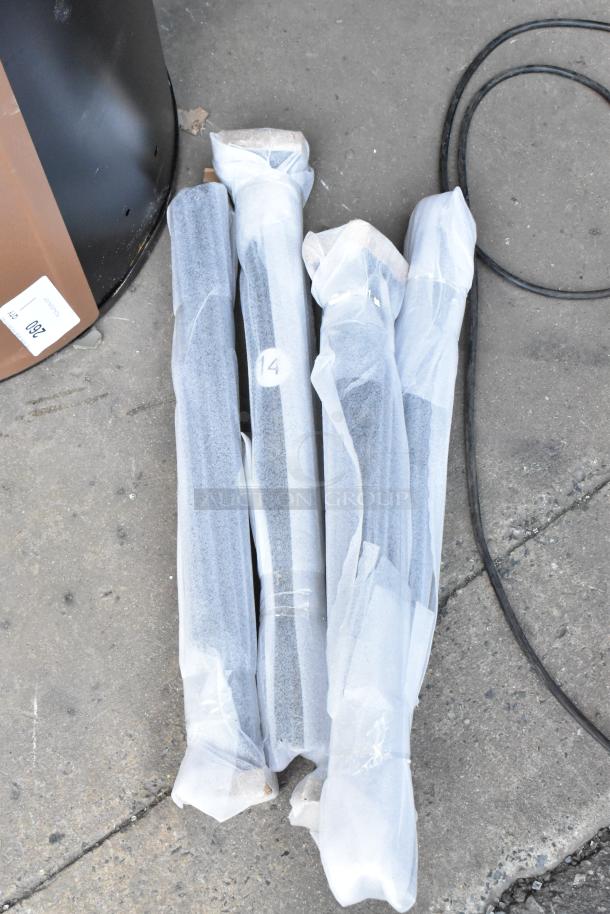 Four wrapped metal rods on the ground, labeled with "14", appear new, possibly industrial use.