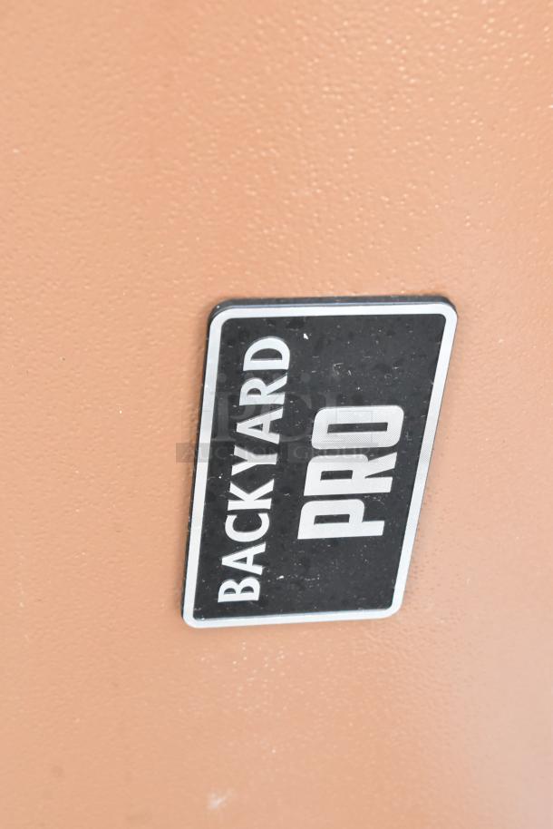Backyard Pro grill with black and white logo. In good condition, ideal for outdoor cooking.