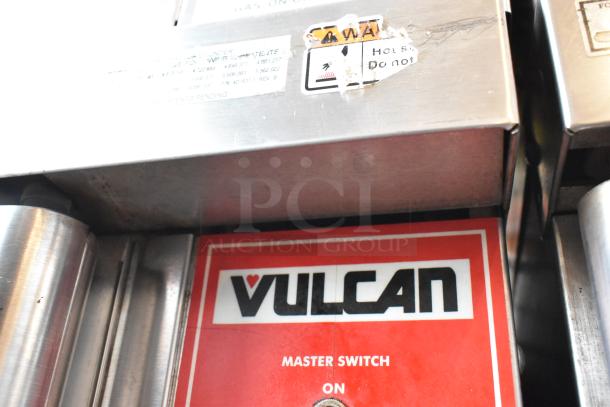 Vulcan commercial grill control panel with red label, "Master Switch On" text, minor wear, warning stickers visible.