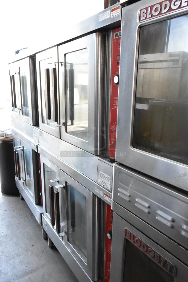 Commercial stainless steel ovens, brands Blodgett and Vulcan, in good condition with glass doors and multiple controls.