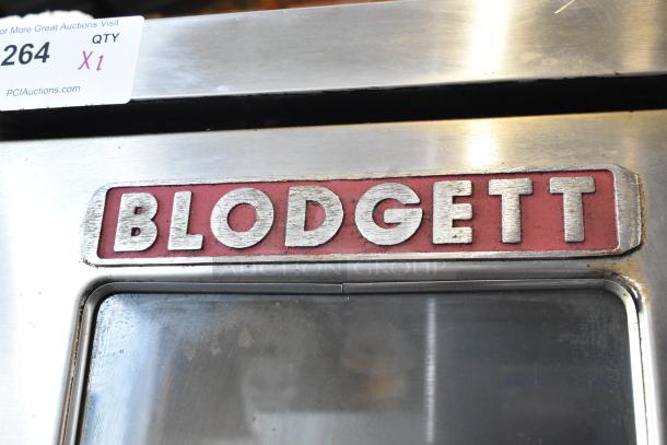 Blodgett commercial oven with visible wear, stainless steel body, labeled with "Blodgett" logo. Auction tag reads "264 QTY X1".