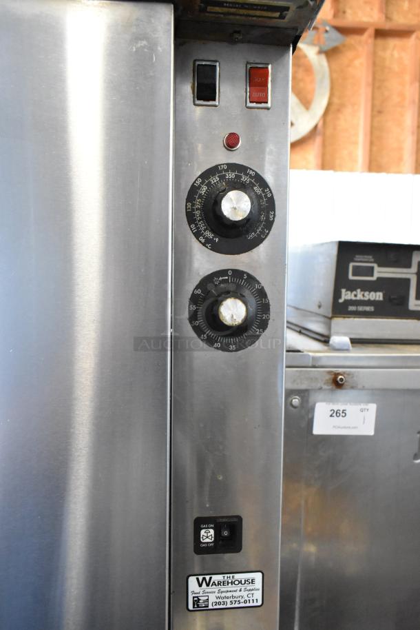 Commercial oven control panel with temperature and timer dials, manual/auto switch, "The Warehouse" label, used condition.