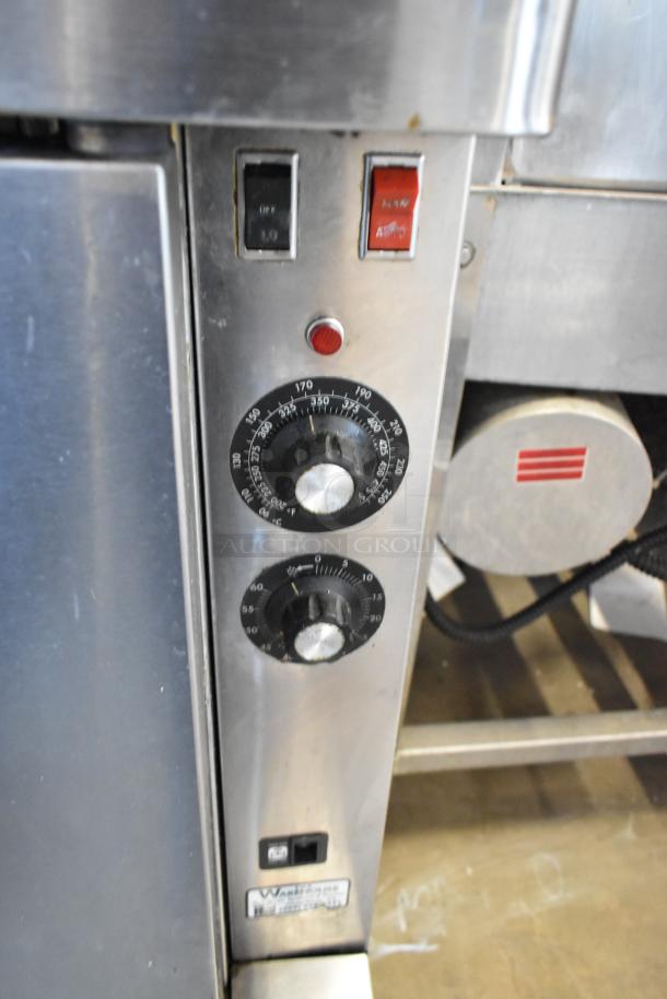 Commercial oven control panel with temperature dials, switches, and indicator light. MarkeWare tag visible, indicating model details.