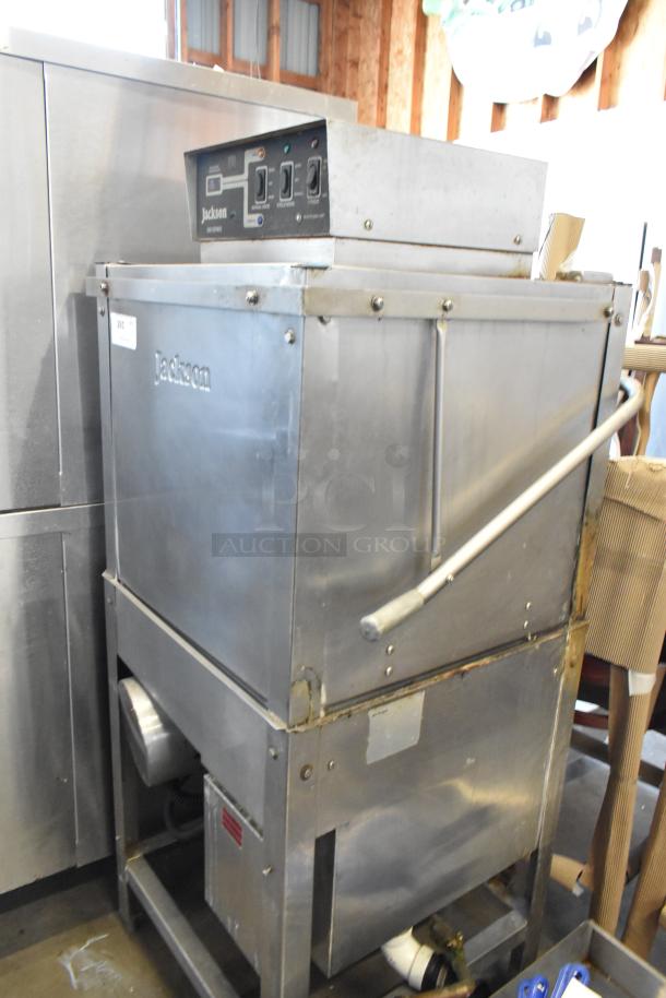 Jackson commercial dishwasher in used condition, stainless steel, visible control panel with dials, item number label attached.