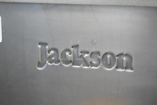 "Jackson" engraved on brushed metal surface, indicating brand or manufacturer. Background is smooth, metallic gray.