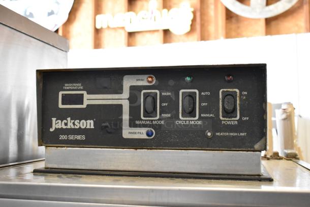 Jackson 200 Series commercial dishwasher control panel with manual and cycle modes, visible wear and rust.