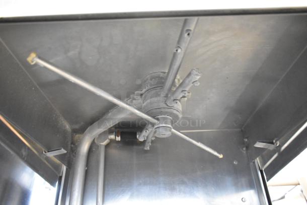 Industrial dishwasher spray arm. Features multiple nozzles, sturdy metal construction. Appears in good condition.