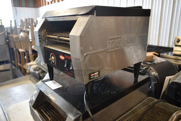 Commercial toaster by Toast-Qwik, model HATCO, stainless steel, used condition, visible controls and branding.