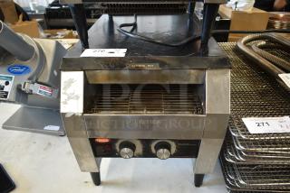 Hatco commercial toaster with dual control knobs, warning labels, and visible wear marks, model number not specified.