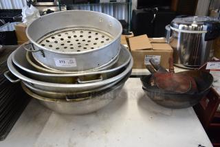 Stack of assorted metal cookware with auction tag "Lot 273" indicating quantity of ten; used condition.