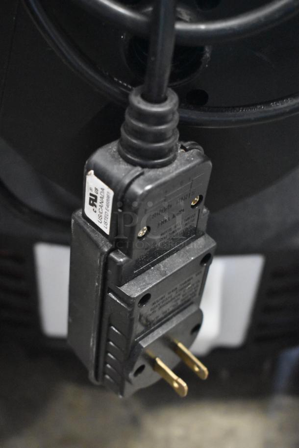 Black electric plug with two-prong connection and AU listing label for US and Canada.