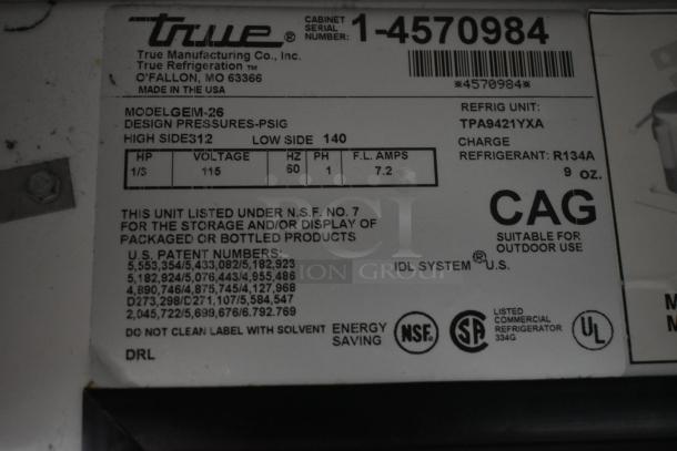 True Manufacturing GEM-26 refrigeration unit label; model details, serial number, voltage 115, uses R134A refrigerant, NSF certified.
