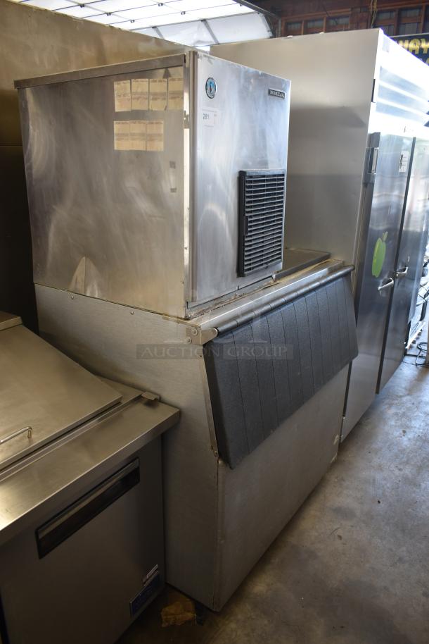Used commercial ice machine, stainless steel, with visible exterior wear. Manitowoc brand. ID tag number 281.