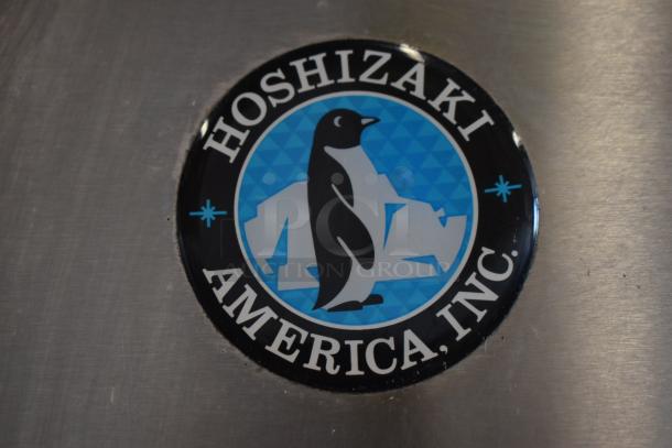 Hoshizaki logo with penguin and iceberg on metal surface, indicating brand authenticity.