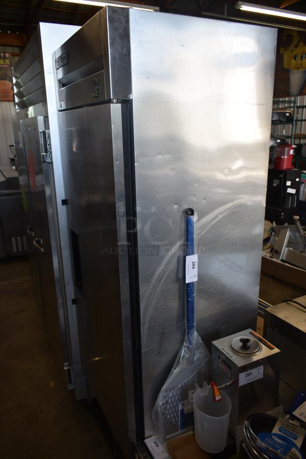 Commercial stainless steel refrigerator, used, with a thermometer, two doors, and visible scuffs; Auction tag "284".