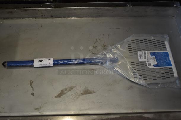 Blue and silver pizza paddle, new in packaging, labeled "284" for auction. Perforated design with barcode visible.
