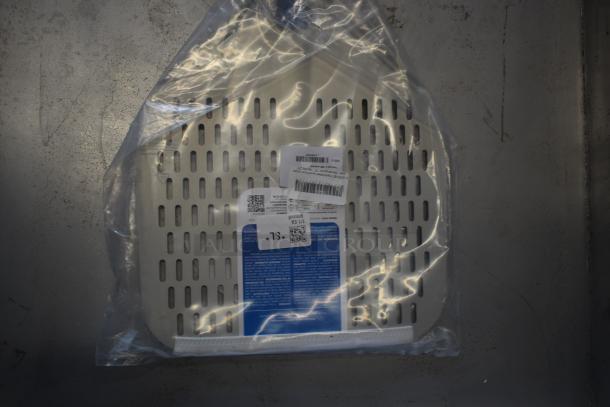 Perforated metal tray in packaging with labels and barcodes. Brand and model information partially visible. New condition.