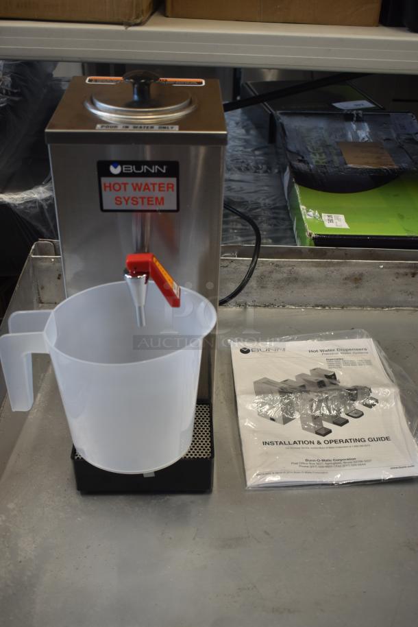 Bunn hot water system with red tap, plastic pitcher, and installation guide. Stainless steel, excellent condition.
