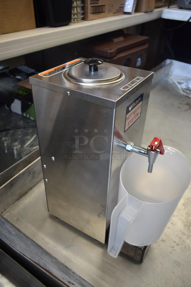 Bunn hot water dispenser in good condition with stainless steel body, red tap, and clear jug. "Hot Water System" label visible.