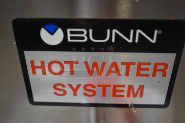 Bunn hot water system label on stainless surface; features bold text and logo. Appears in good condition.