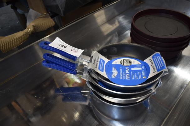 Set of three 8-inch Vollrath fry pans with blue handles, new condition, labeled with auction tag 286.