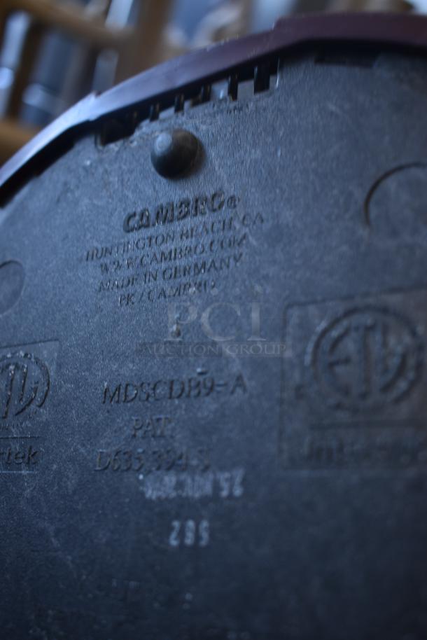 Camera base with markings, "Made in Germany" indicating origin. Model MDSCDB9-A, patent number D6533945 visible.