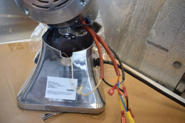 Estella machinery base with visible wiring and a label showing model and serial numbers, silver finish, moderate wear.