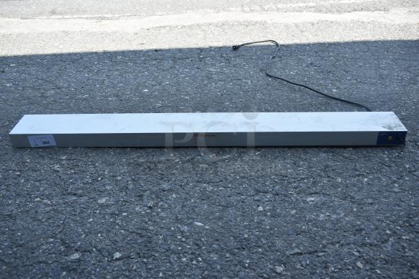 Rectangular metal light fixture with power cord, caution marking visible, tag labeled "290." Good condition.