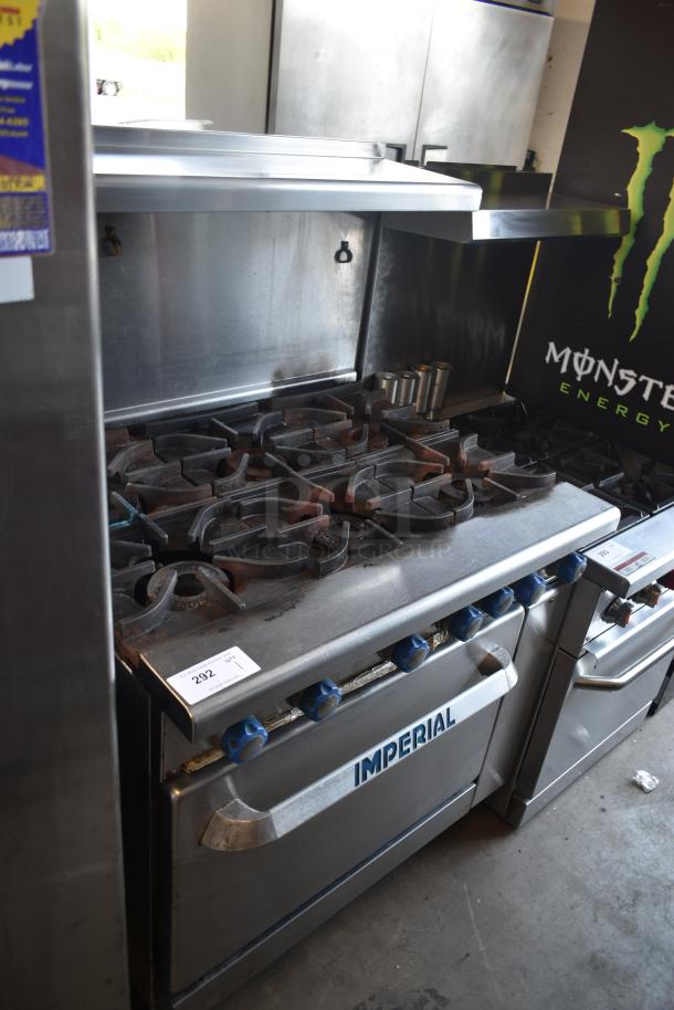 Imperial commercial gas range with six burners, stainless steel, used condition, auction tag 292 visible.