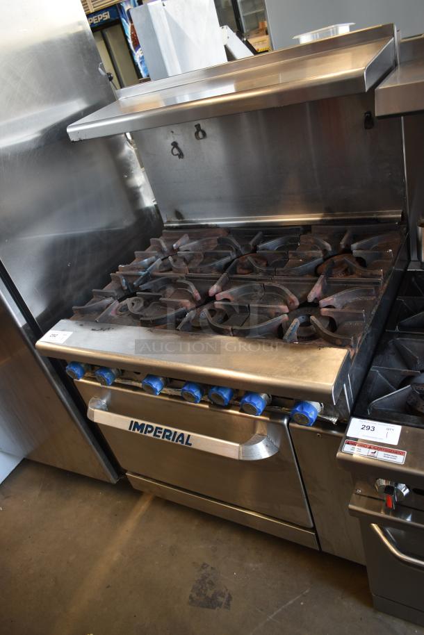 Imperial commercial gas range with six burners, used condition, blue control knobs, stainless steel, label indicates model 293.