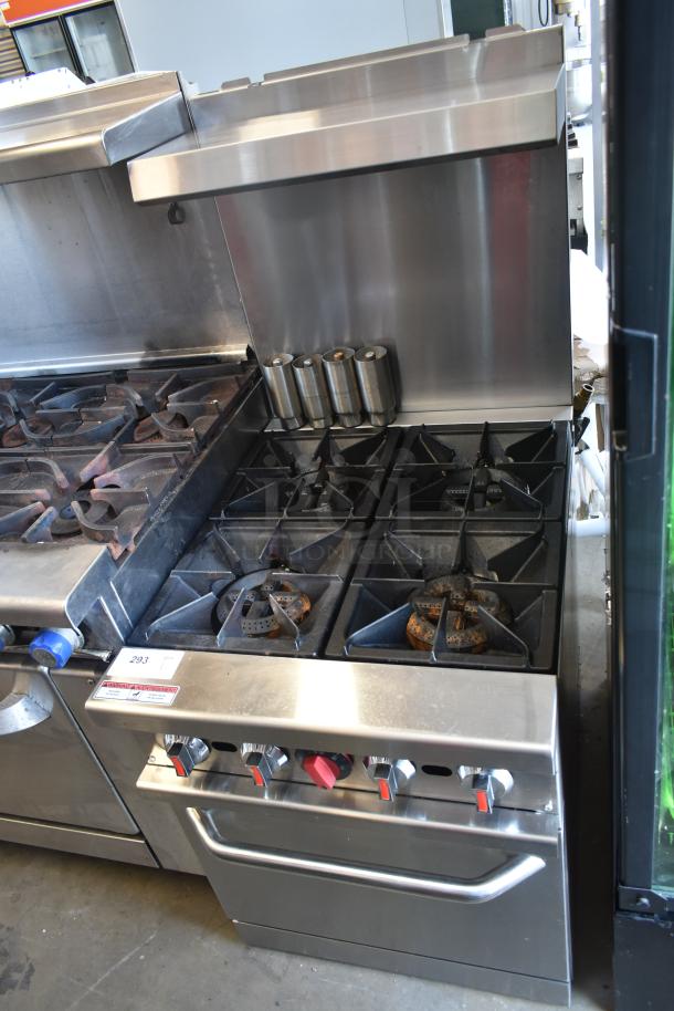 Commercial stainless steel gas stove with six burners and control knobs, showing signs of use. Auction lot tag number 293 attached.