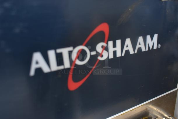 Alto-Shaam logo on a commercial kitchen appliance, indicating quality cooking equipment. Dark blue background.
