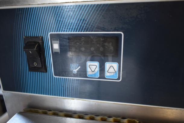 Commercial kitchen oven control panel with power switch and temperature buttons, indicating functional settings. Slight wear.