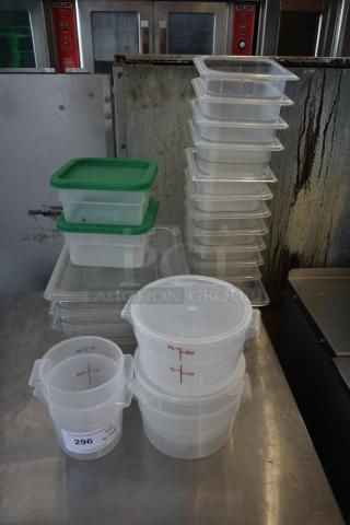 Stack of clear plastic storage containers with green lids and measuring markings. Includes a 2-quart marked container with auction label 296.