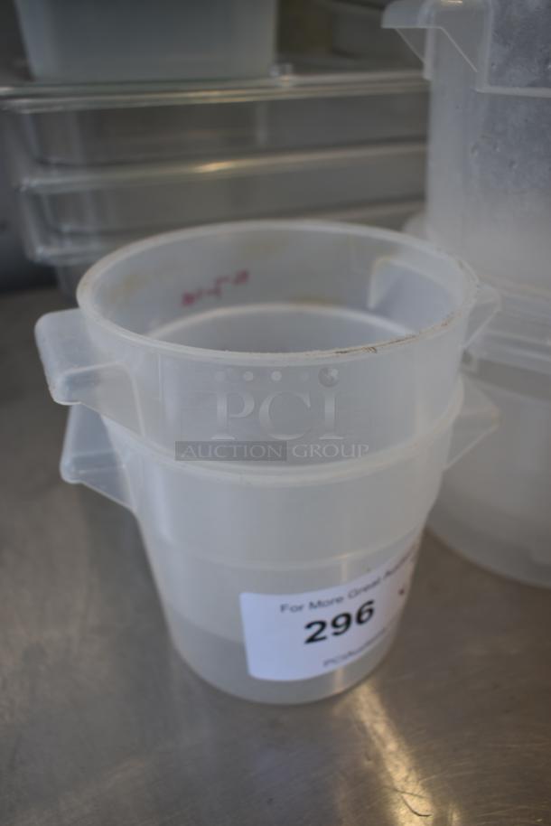 Clear plastic stackable storage container with two handles. Auction label reads "296." Moderate wear visible.