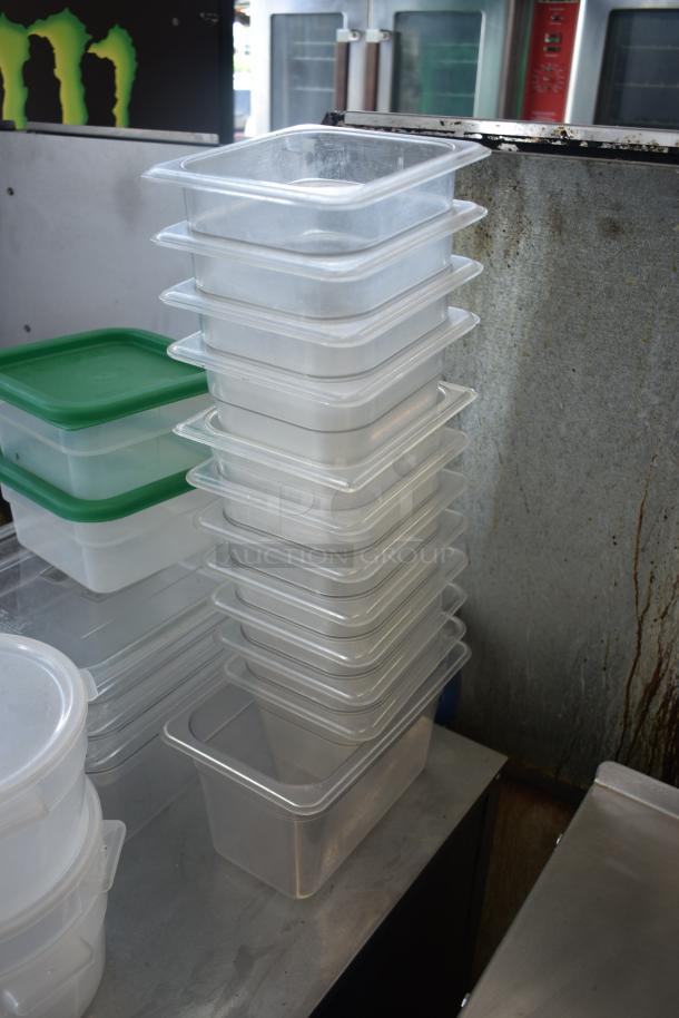 Stack of clear plastic storage containers, new condition, various sizes, with lids. Ideal for kitchen or pantry organization.