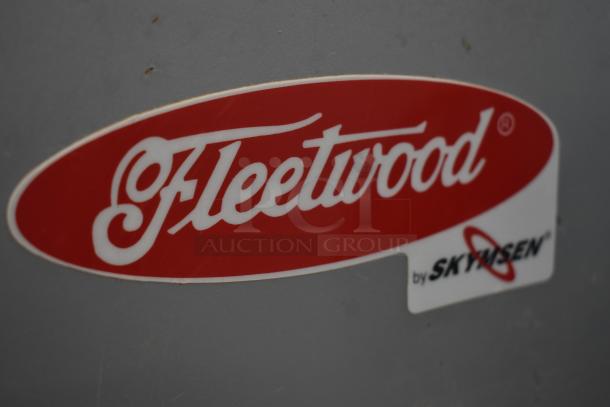 Fleetwood logo sticker by Skyrisen on a gray surface, indicating brand and model information.