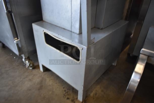 Industrial metal box with open front, likely used for storage. Slight wear visible, sturdy condition, grey finish.