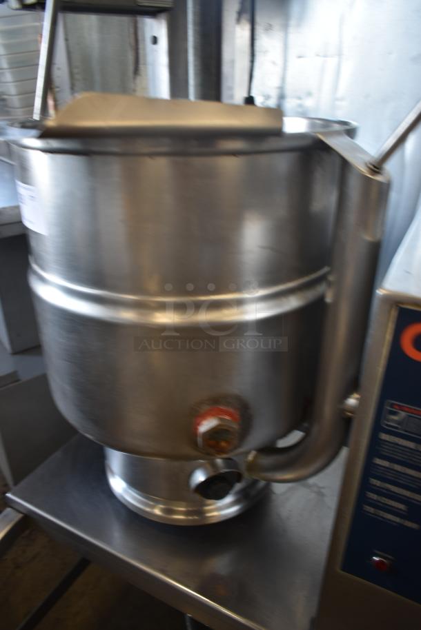 Commercial stainless steel tilting kettle with spout, used condition, visible control panel on the side.