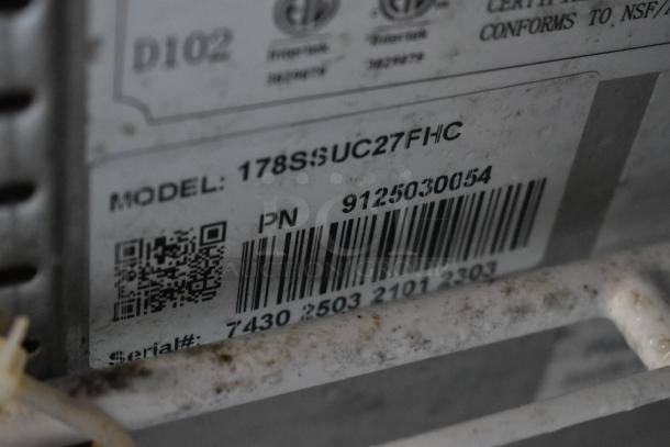Close-up of a label on equipment, showing model 178SSUC27FHC, serial number 7430250321012303, and a barcode.