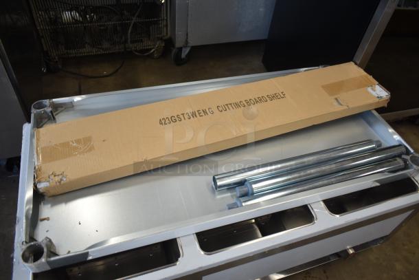 Cardboard box labeled "423GST3WENG Cutting Board Shelf," includes metal rods, appears new, for commercial use.